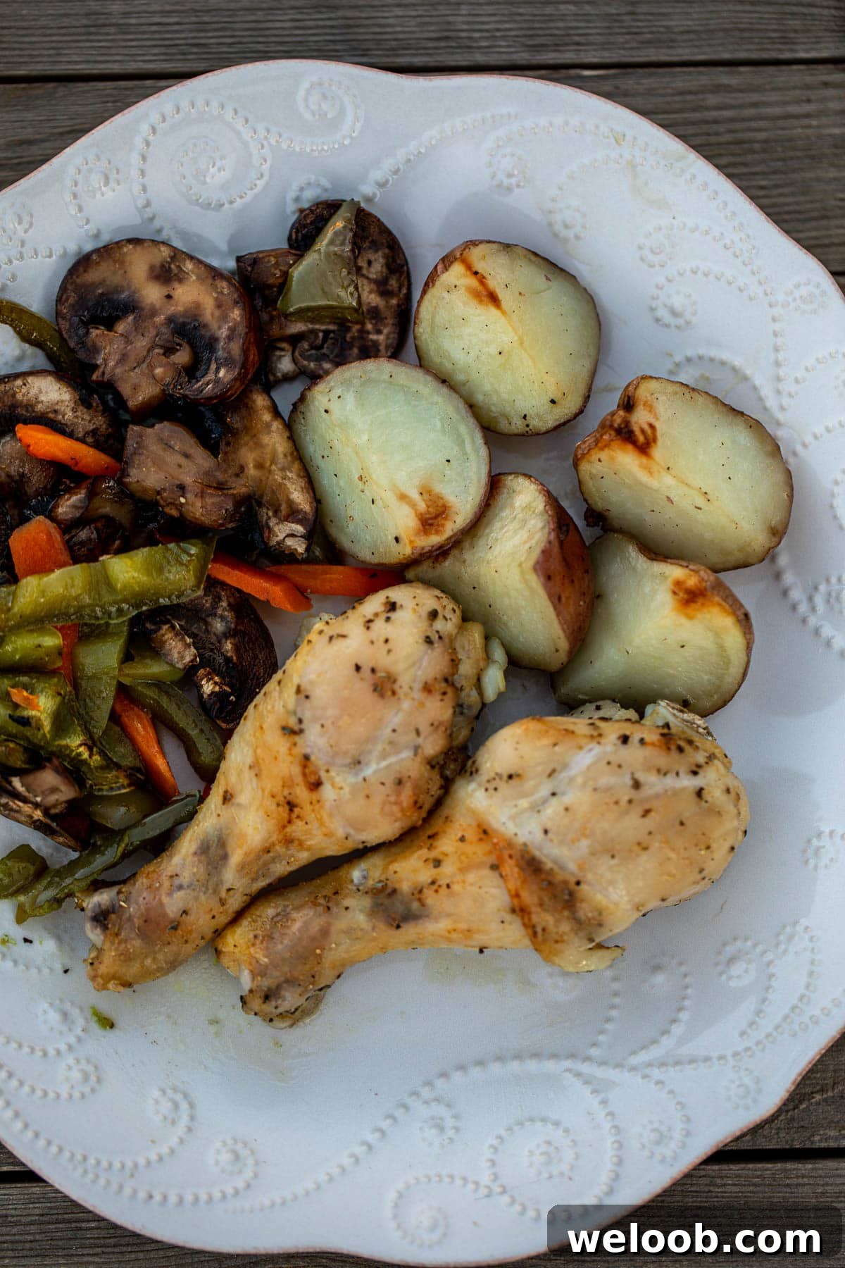 A plate of chicken potatoes and veggies