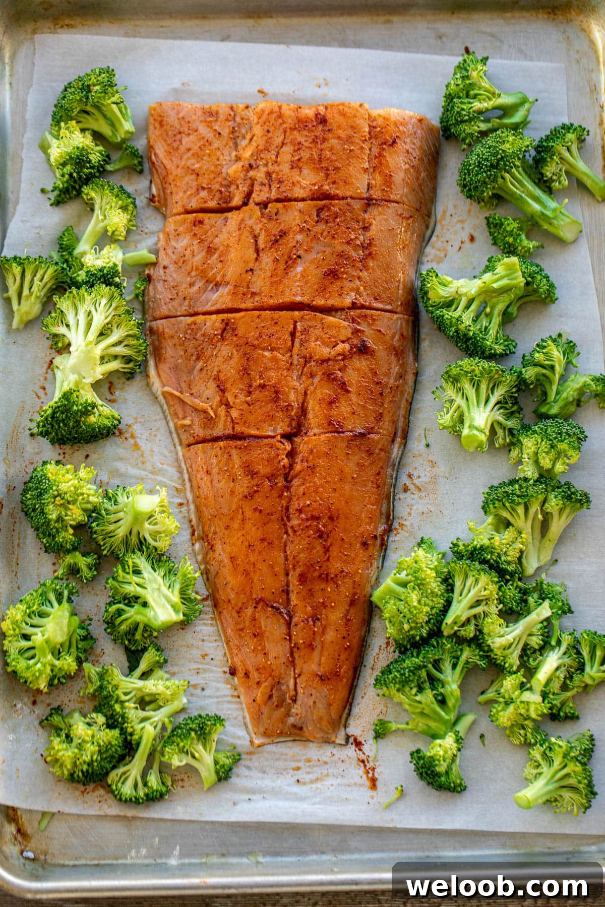 seasoned salmon and broccoli on a sheet pan