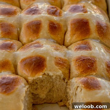 Hot Cross Buns in a baking dish with one removed