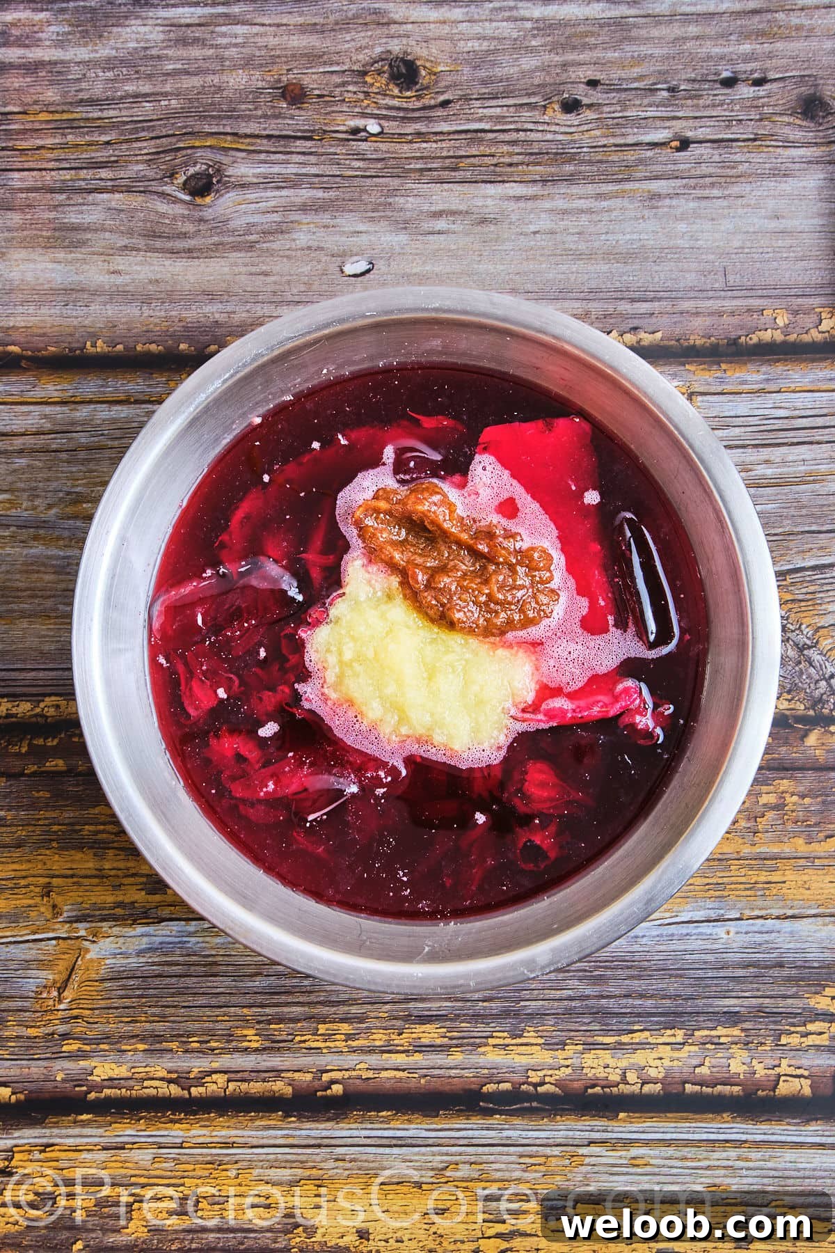 Pineapple and date puree added to a pot of hibiscus tea.