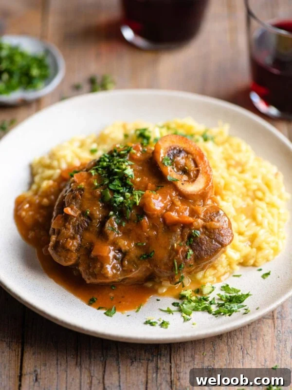 Osso Bucco on a plate of saffron risotto and topped with gremolata