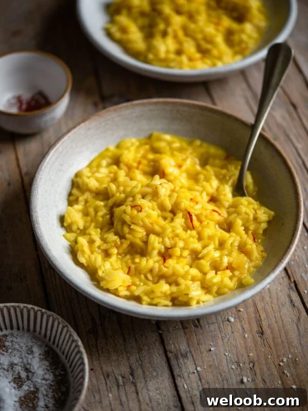 Saffron risotto in a bowl with a fork
