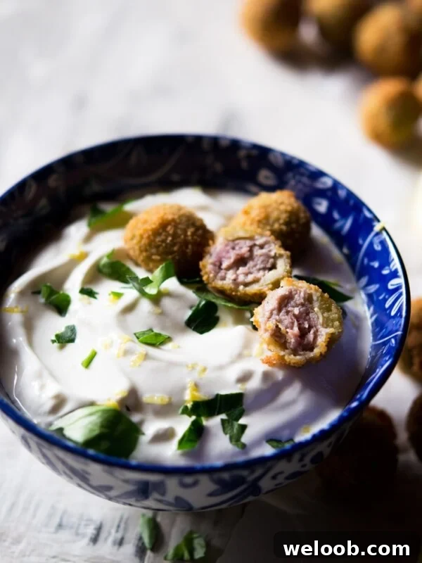 cut open stuffed olives with a sour cream dip
