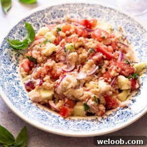 A cropped image of Panzanella salad in a blue bowl.