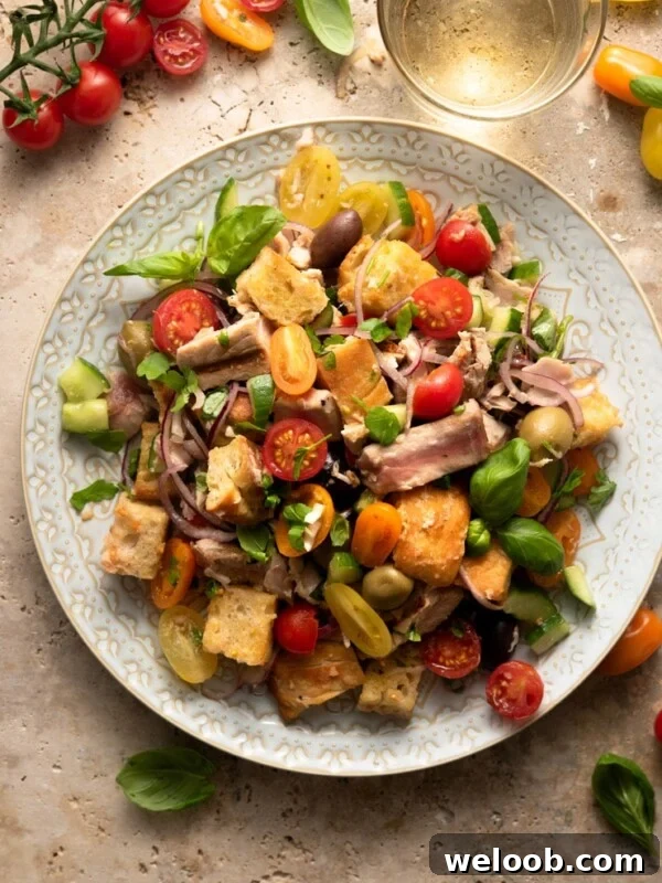 An overhead shot of a tuna panzanella salad on a large plate