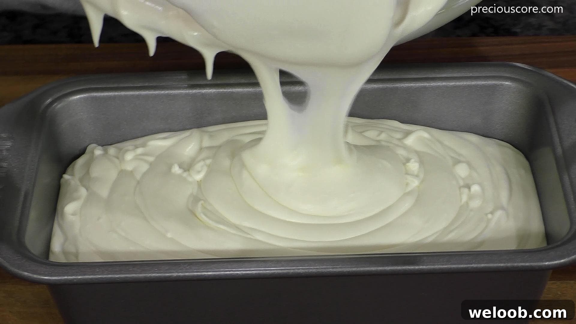 Coconut Ice Cream Mixture pouring into a loaf pan