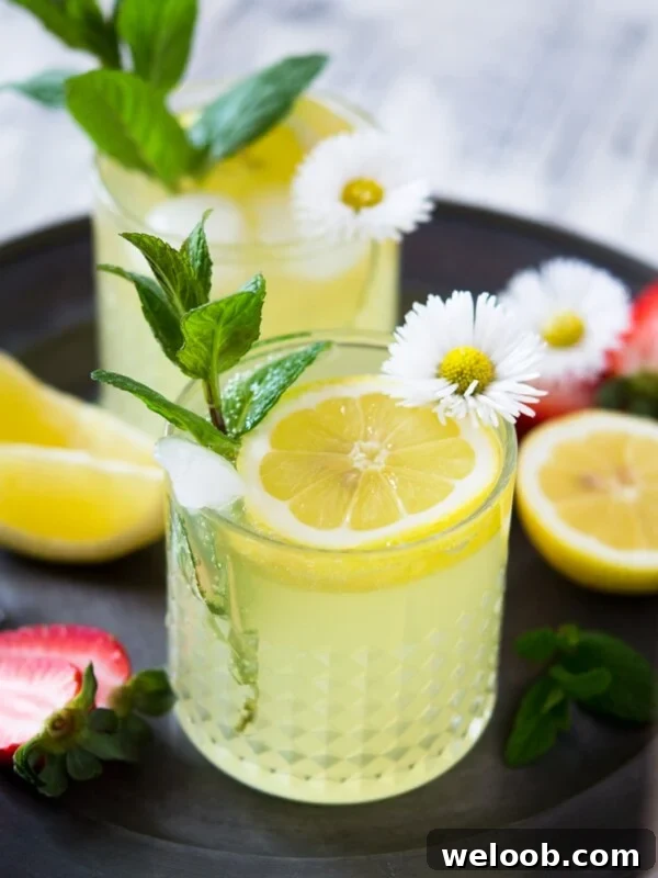 a limoncello cocktail garnished with mint and dasies