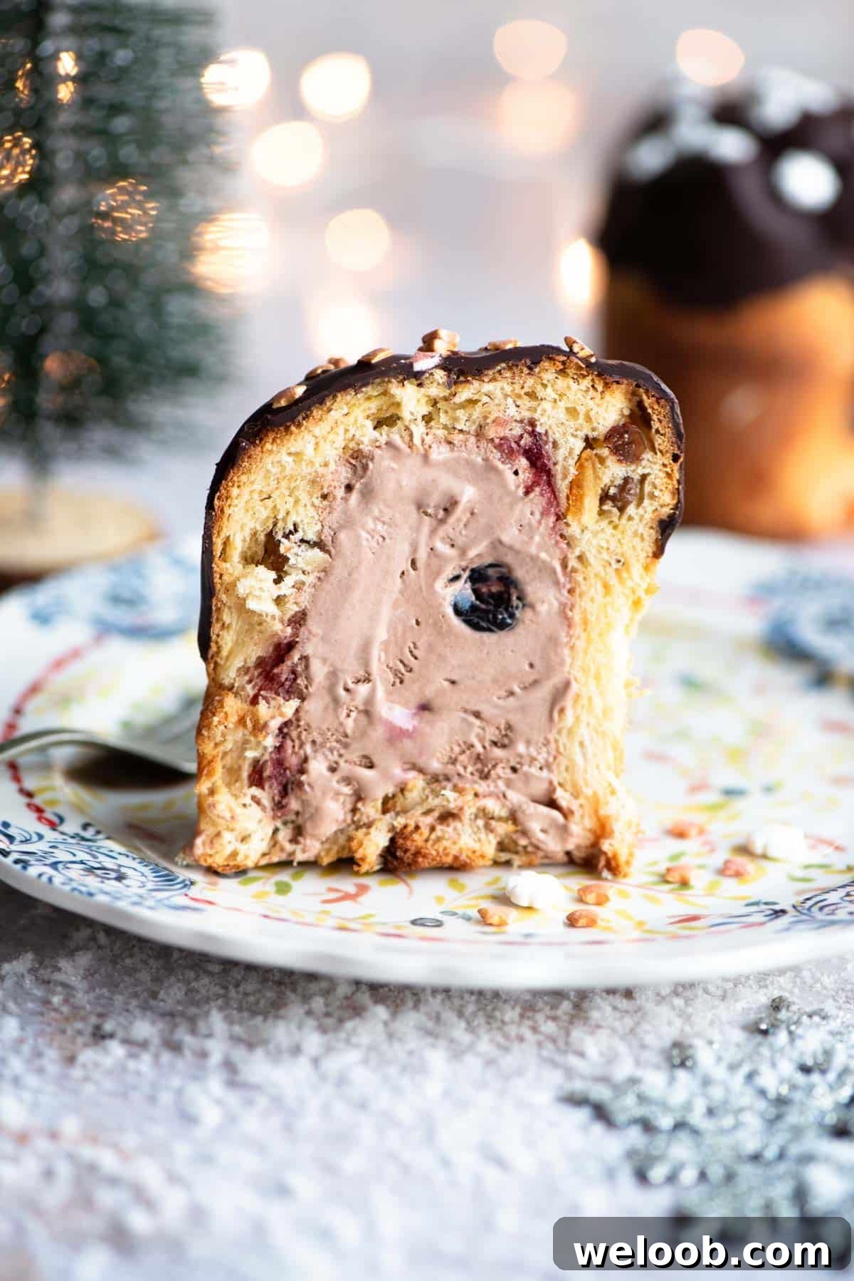 A mini Panettone cut in half showing it stuffed with cherry and chocolate ice cream.