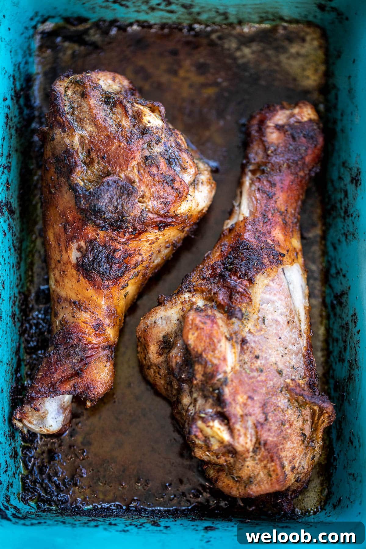 Cooked turkey legs in baking dish.