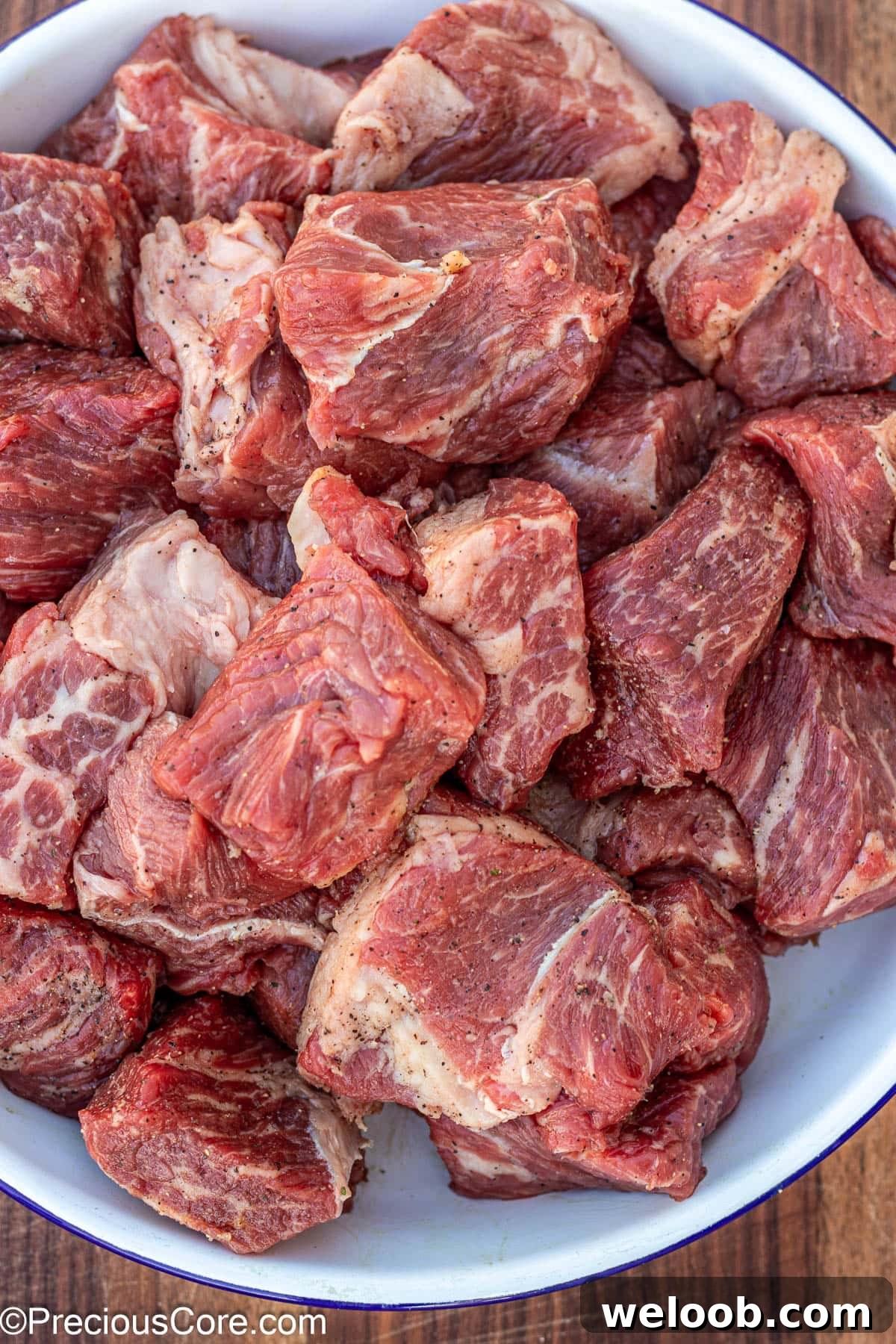 Seasoned beef in a white bowl.