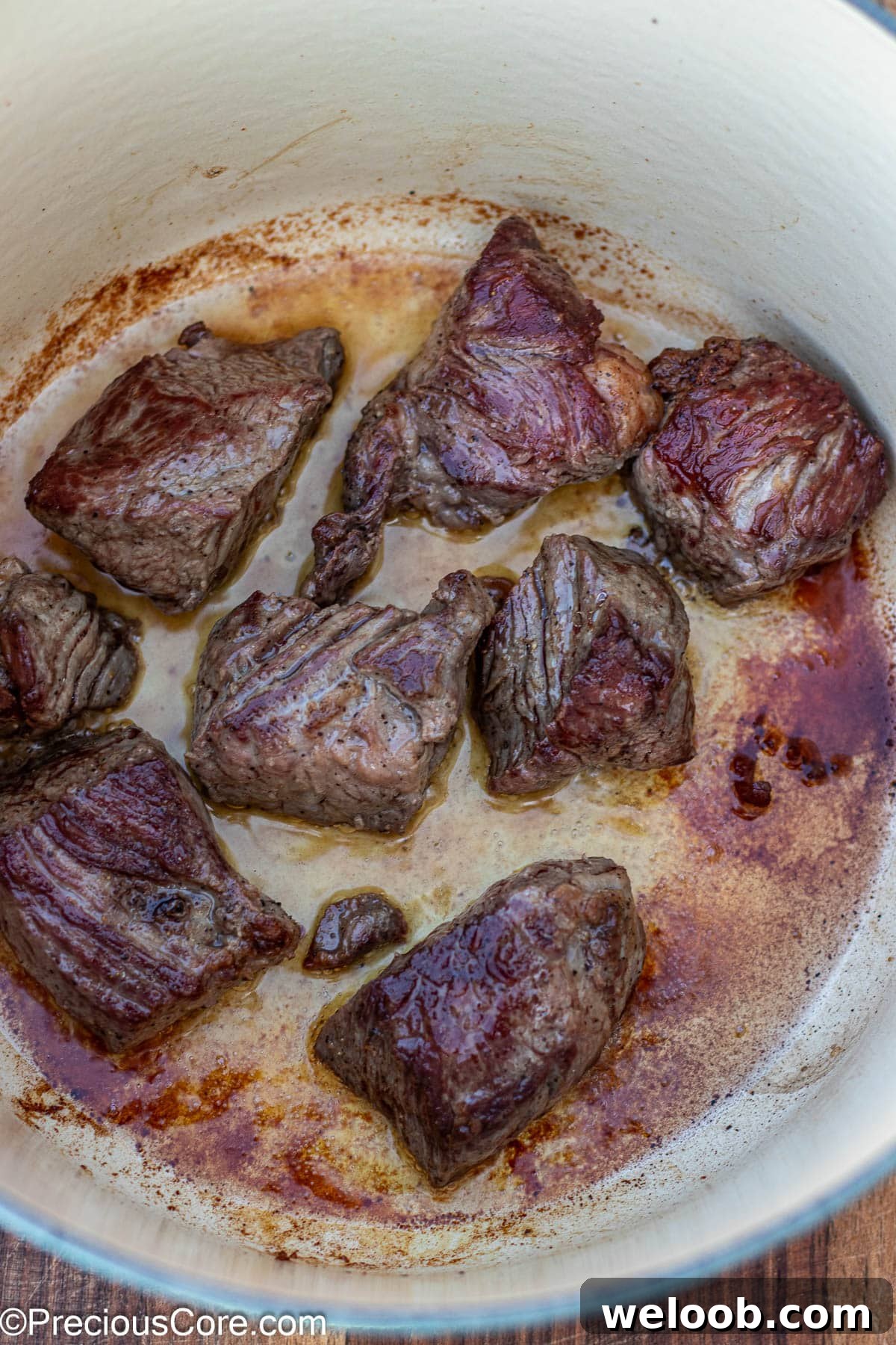 Beef browning in a dutch oven.