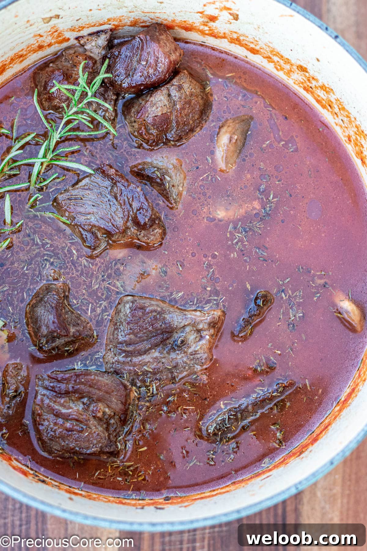 Dutch oven with beef, broth, crushed tomatoes.