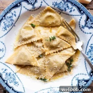 A cropped image of triangoli pasta in a blue patterned bowl.