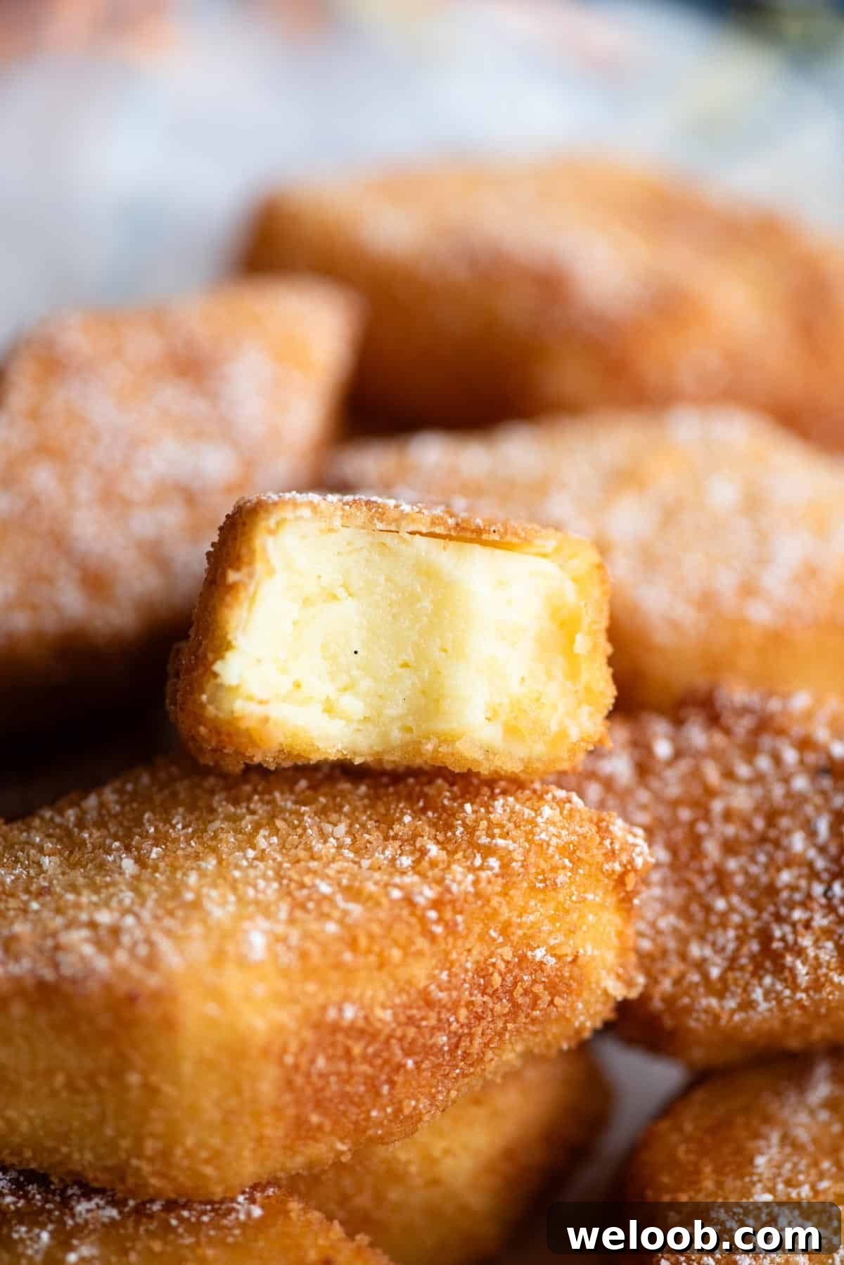 A close up of Crema Fritta (deep fried custard) cut in half showing the inside.