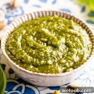 A close up cropped image of pistachio pesto in a small dish.