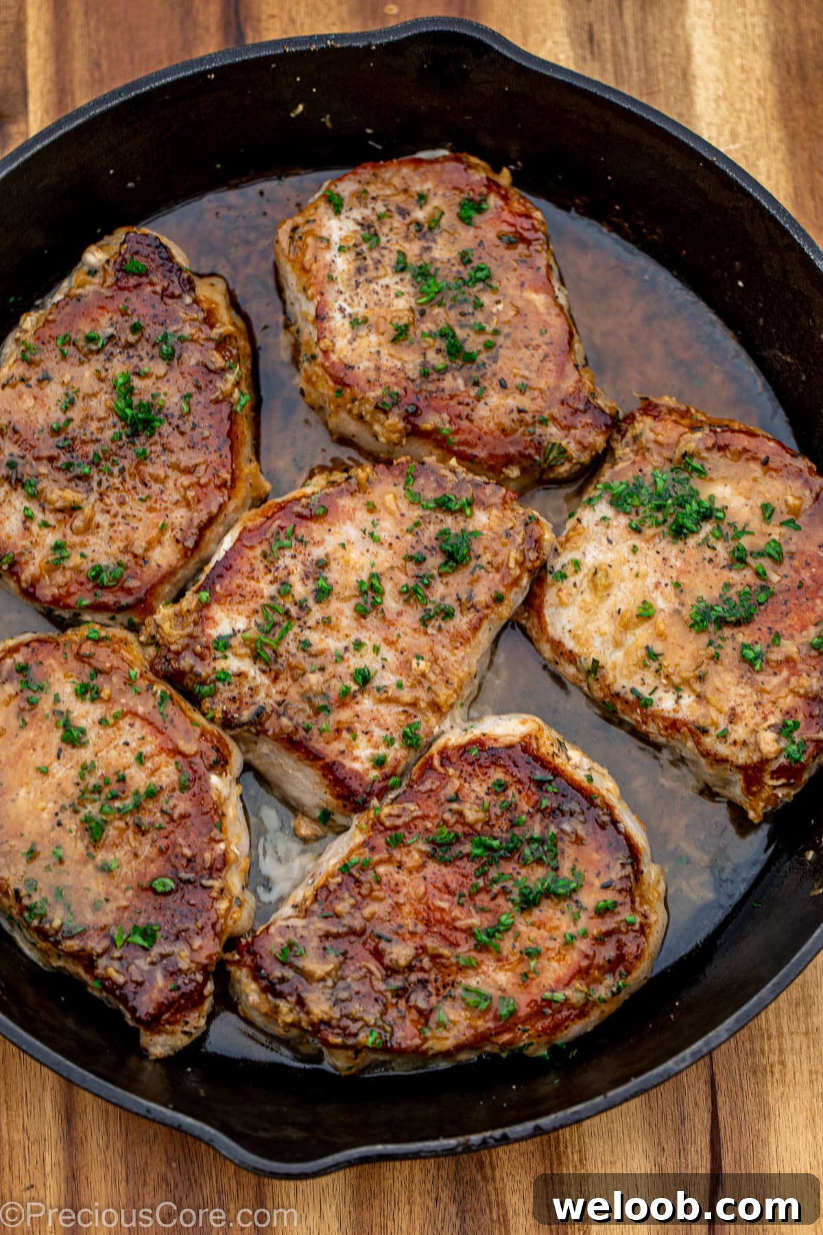 Cooked pork chops in butter sauce.