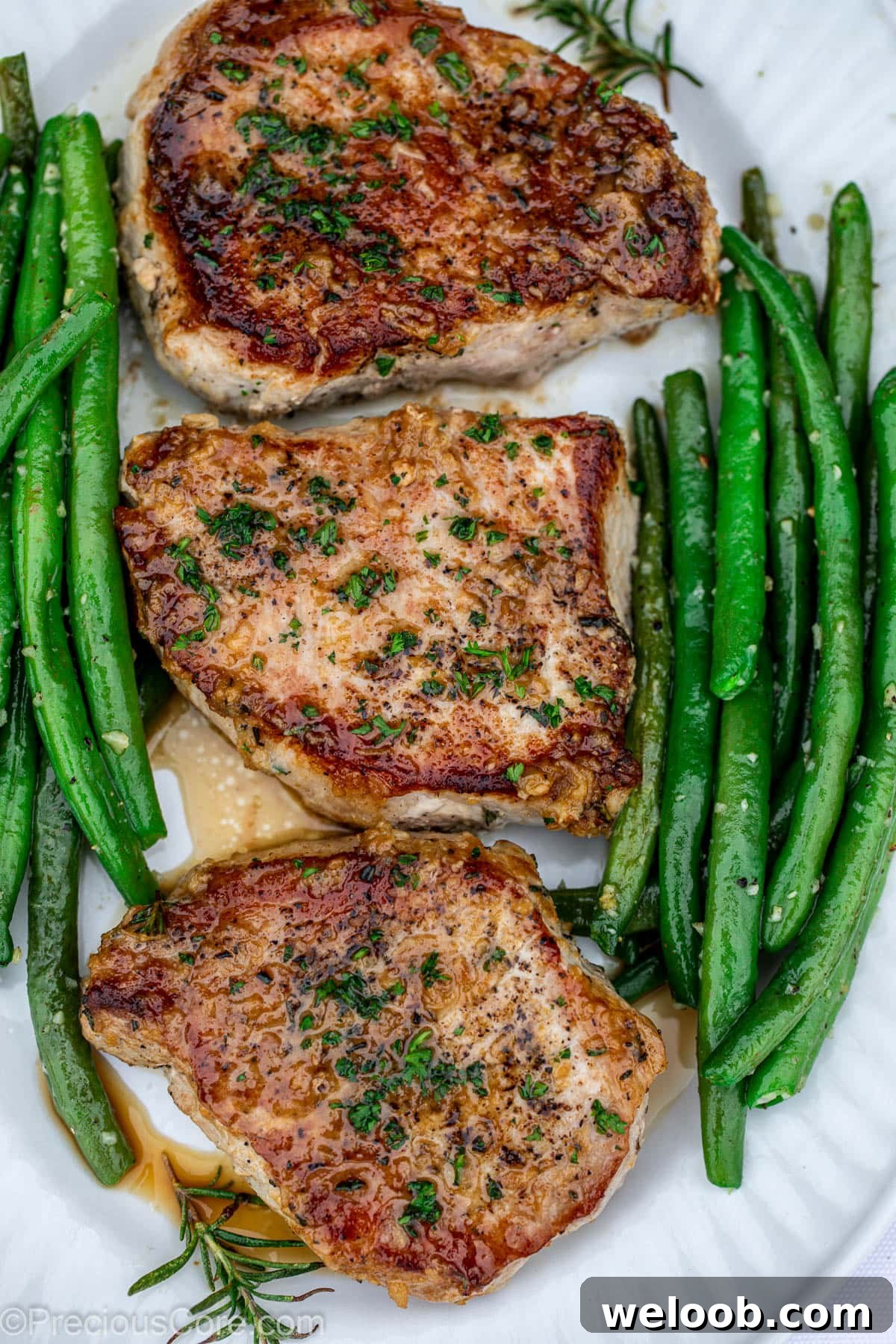 Garlic Butter Green Beans Recipe with Crispy Garlic 11 Pork Chops in a pan with green beans.