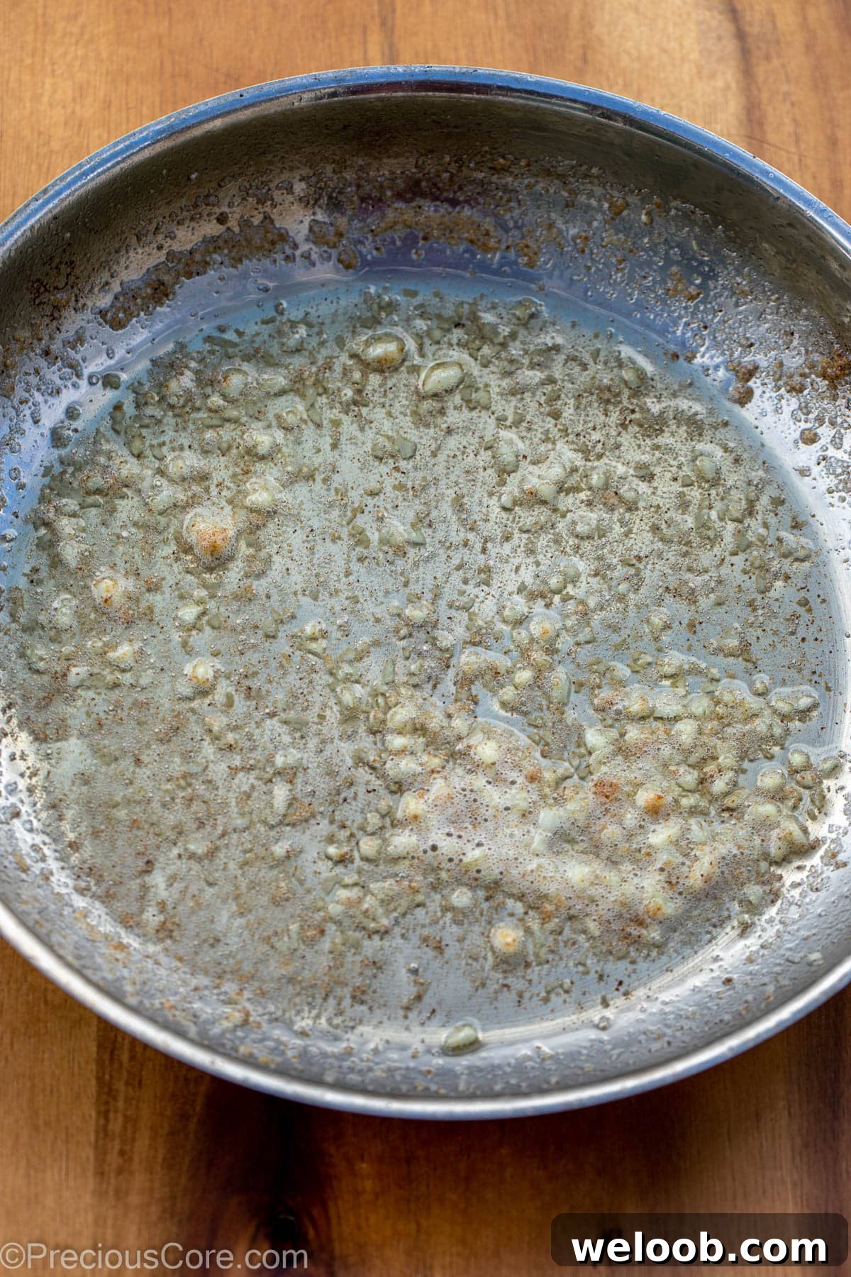 Garlic Butter Green Beans Recipe with Crispy Garlic 8 Garlic and butter in a skillet.