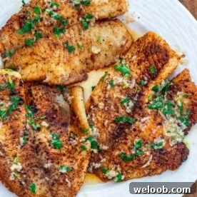 Lemon butter tilapia fillets on a plate