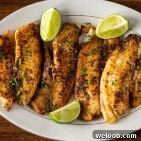 Pan Seared Tilapia on a serving tray with lime wedges