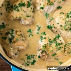 Chicken in White Sauce in a cast iron braiser.