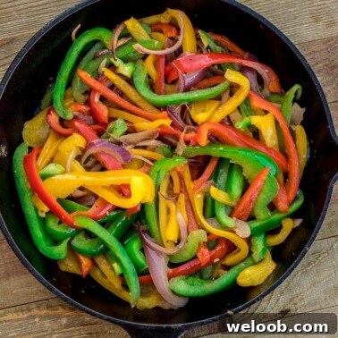 Sauteed peppers and onions in a skillet