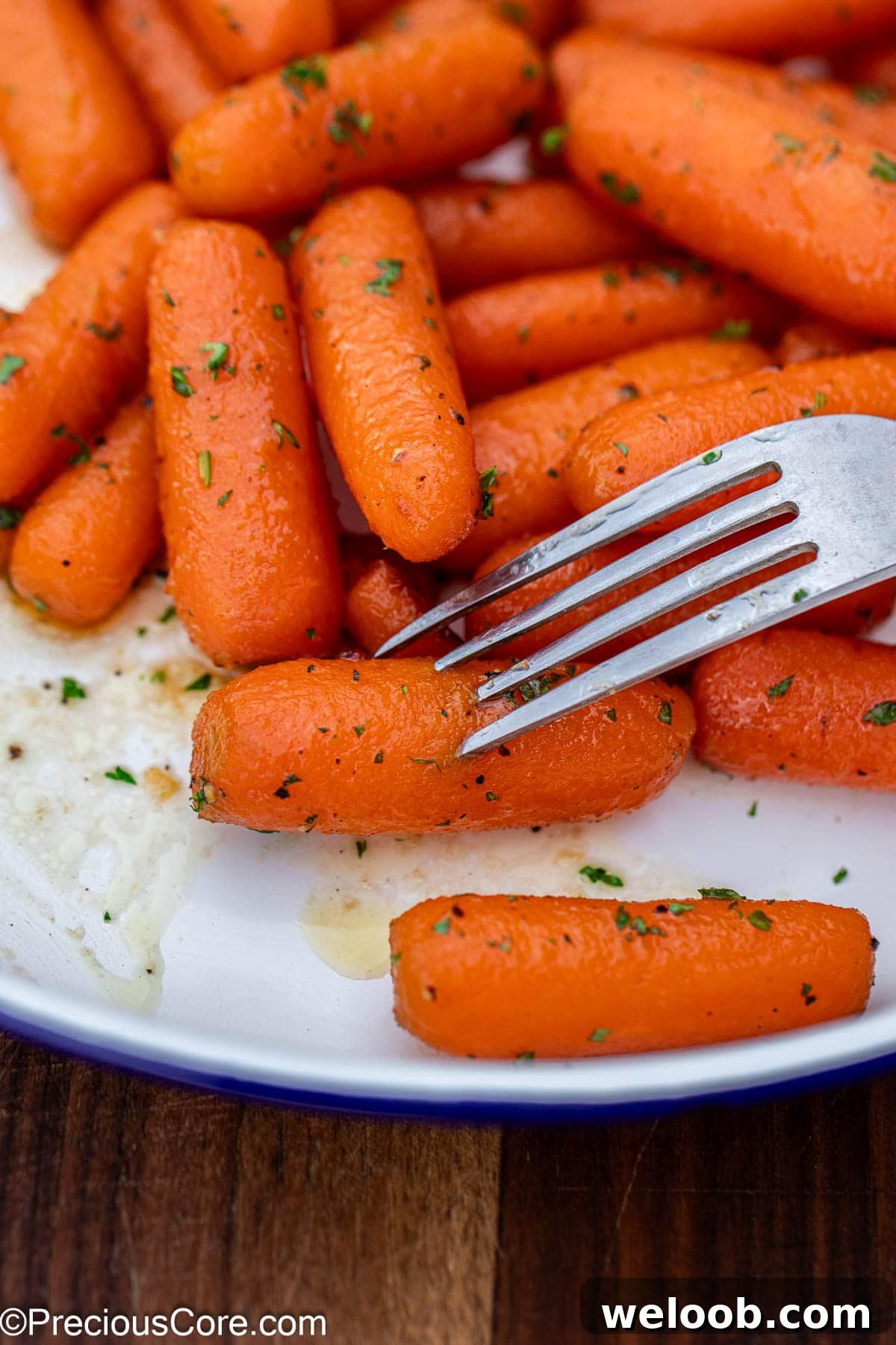 Fork piercing into a cooked carrot.
