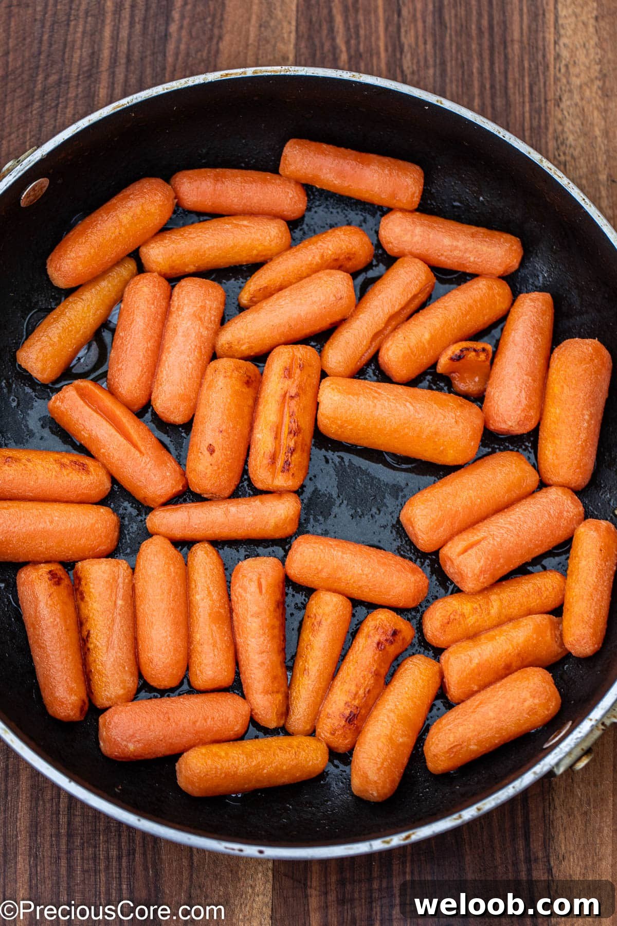 Carrots cooked in butter in skillet.