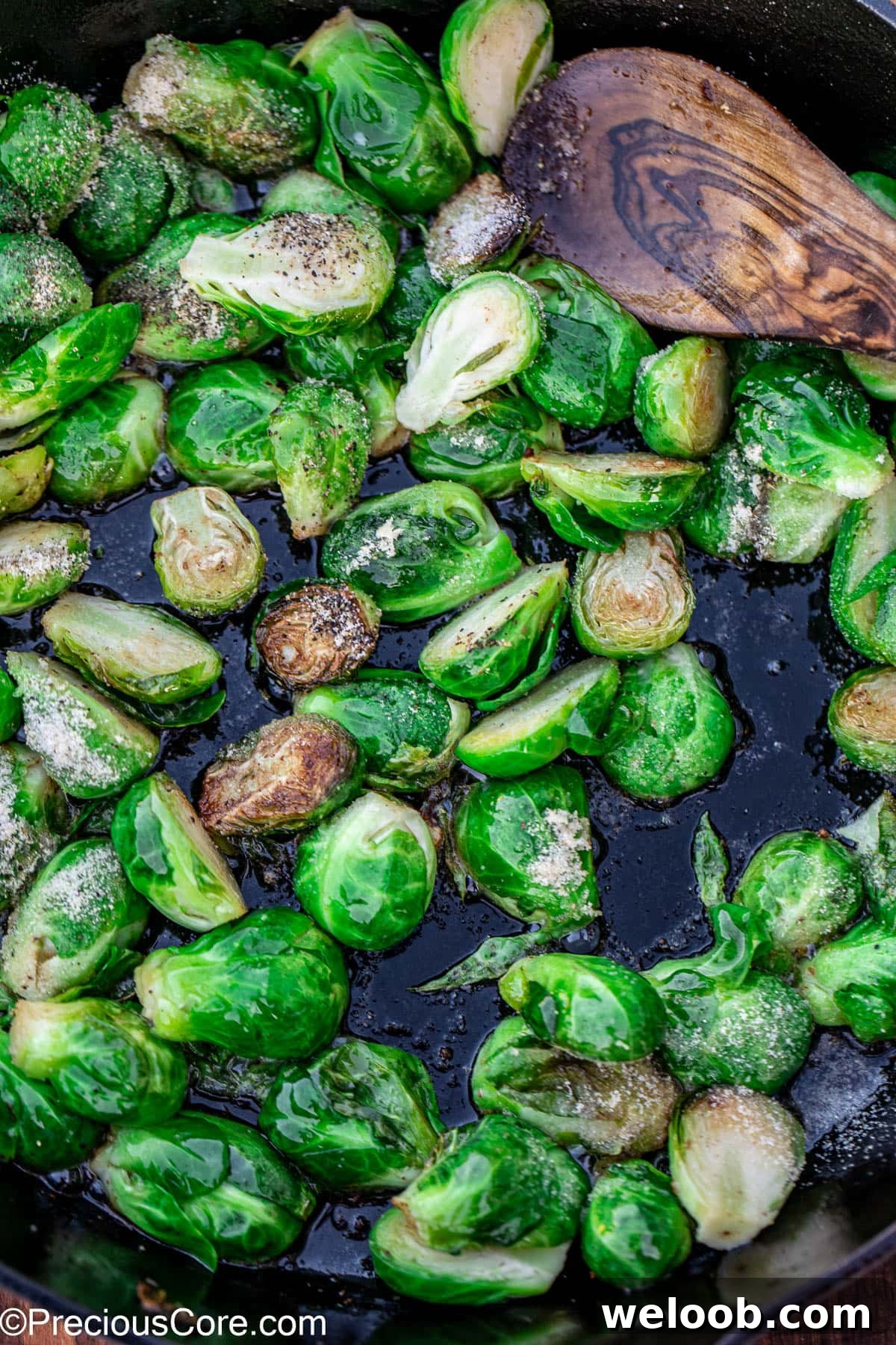 Bright green Brussels sprouts sprinkled with salt and pepper.