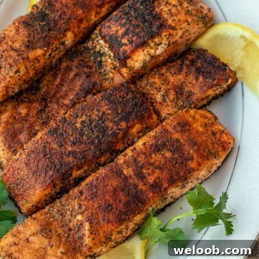 Pan-Seared Lemon Butter Salmon with Garlic and Herbs 16 Four grilled salmon fillets on a serving platter