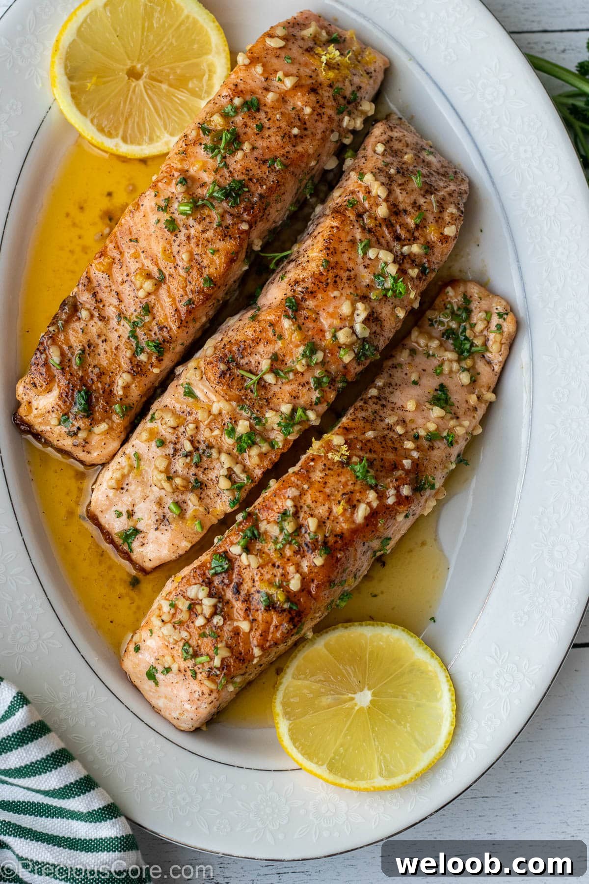 Pan-Seared Lemon Butter Salmon with Garlic and Herbs 8 Lemon Butter Salmon served on a platter