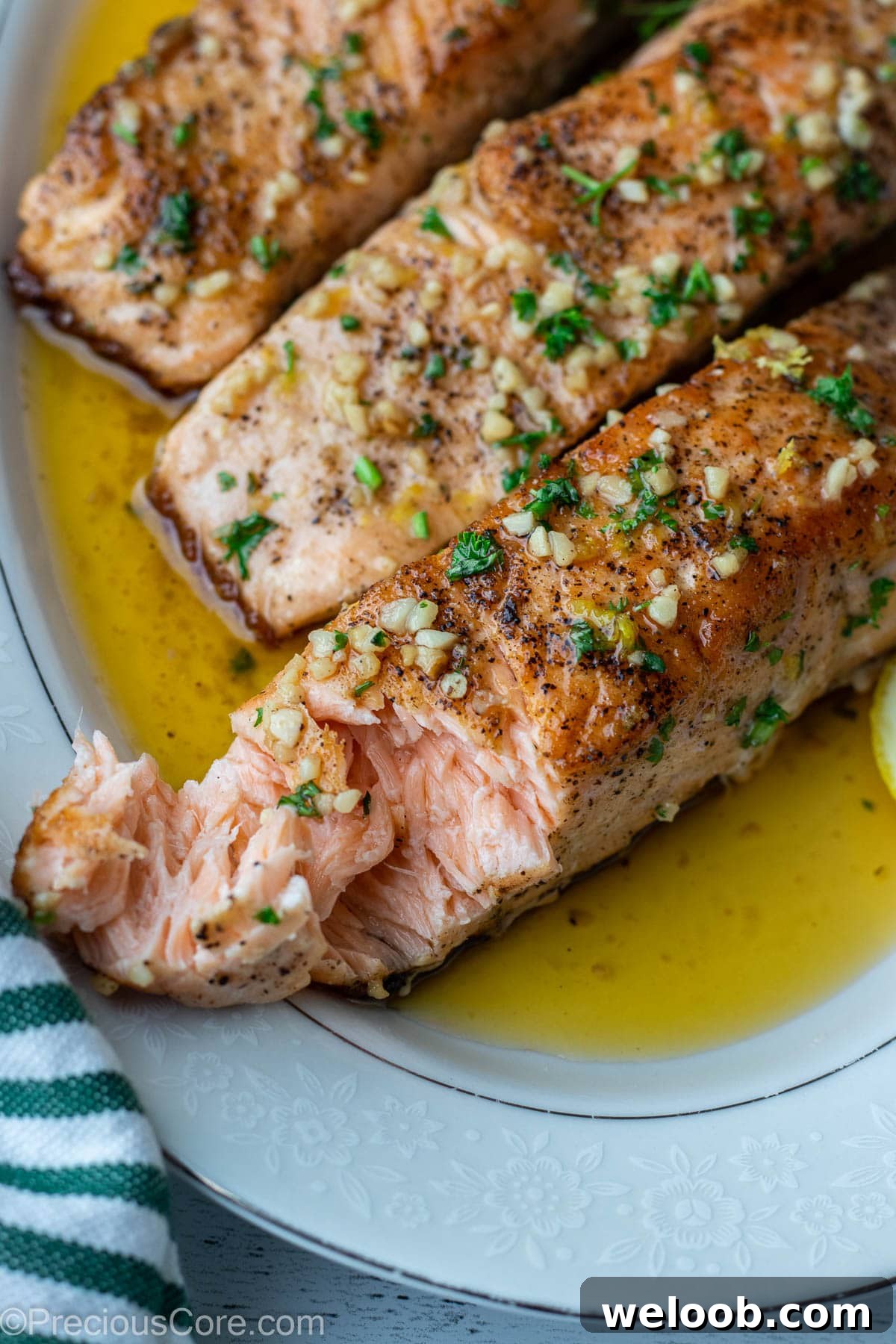 Pan-Seared Lemon Butter Salmon with Garlic and Herbs 9 Faked salmon on a platter to show juiciness.
