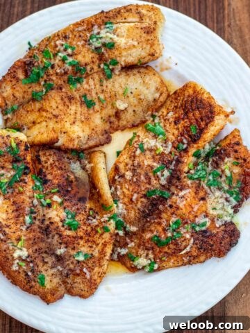 Lemon butter tilapia fillets on a plate