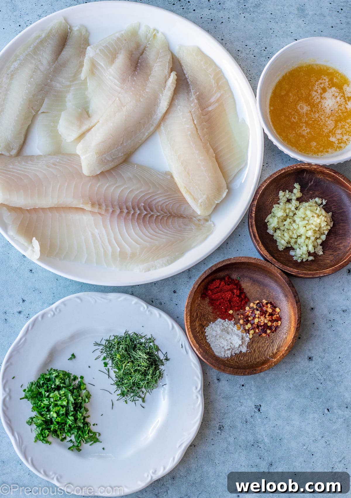 Ingredients for Garlic Butter Tilapia on a slab