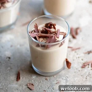 A close up of coffee ricotta cream (ricotta al caffe) in a small glass.