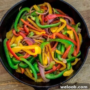Sauteed peppers and onions in a skillet