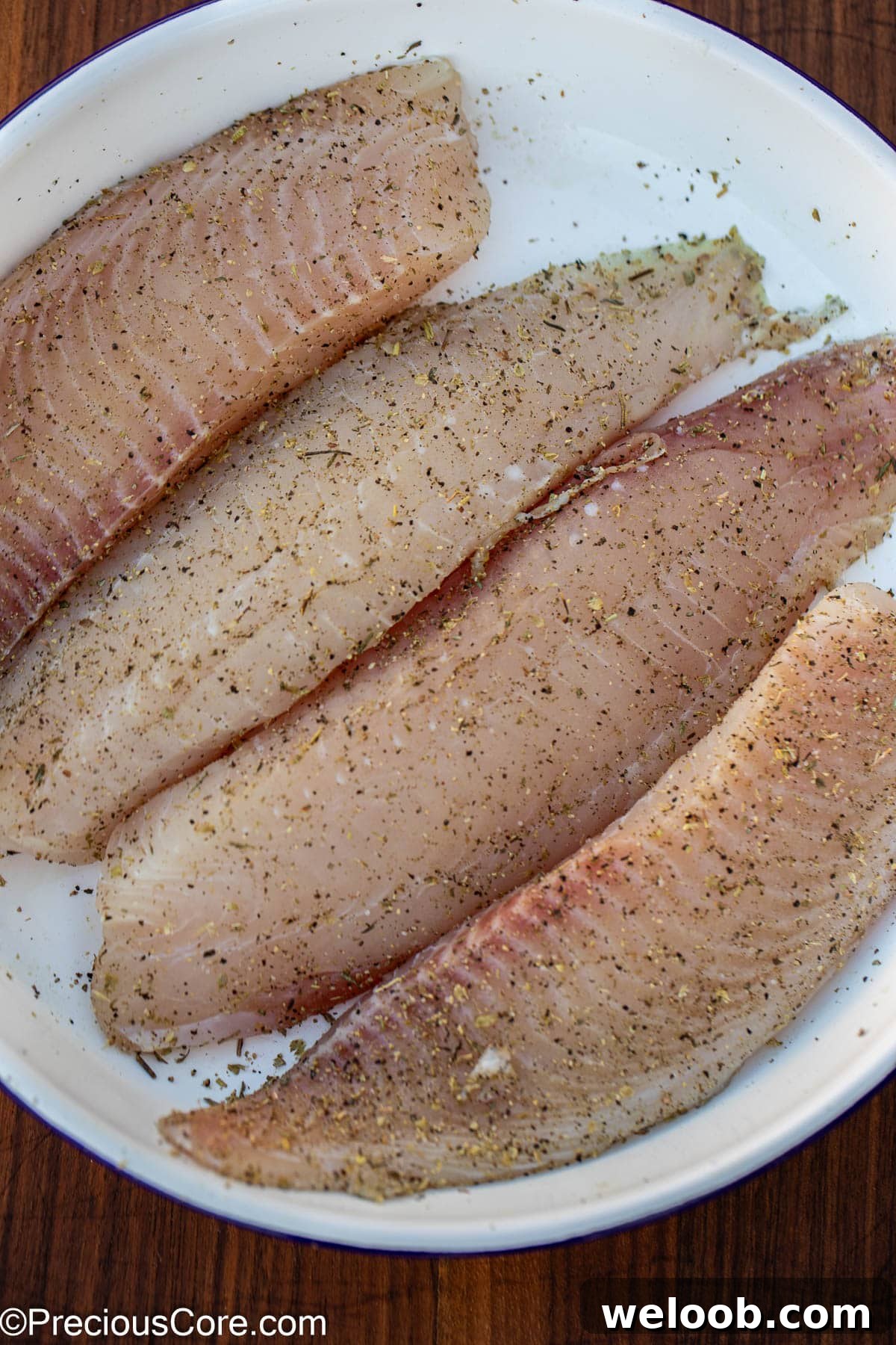 Raw seasoned fish fillets.