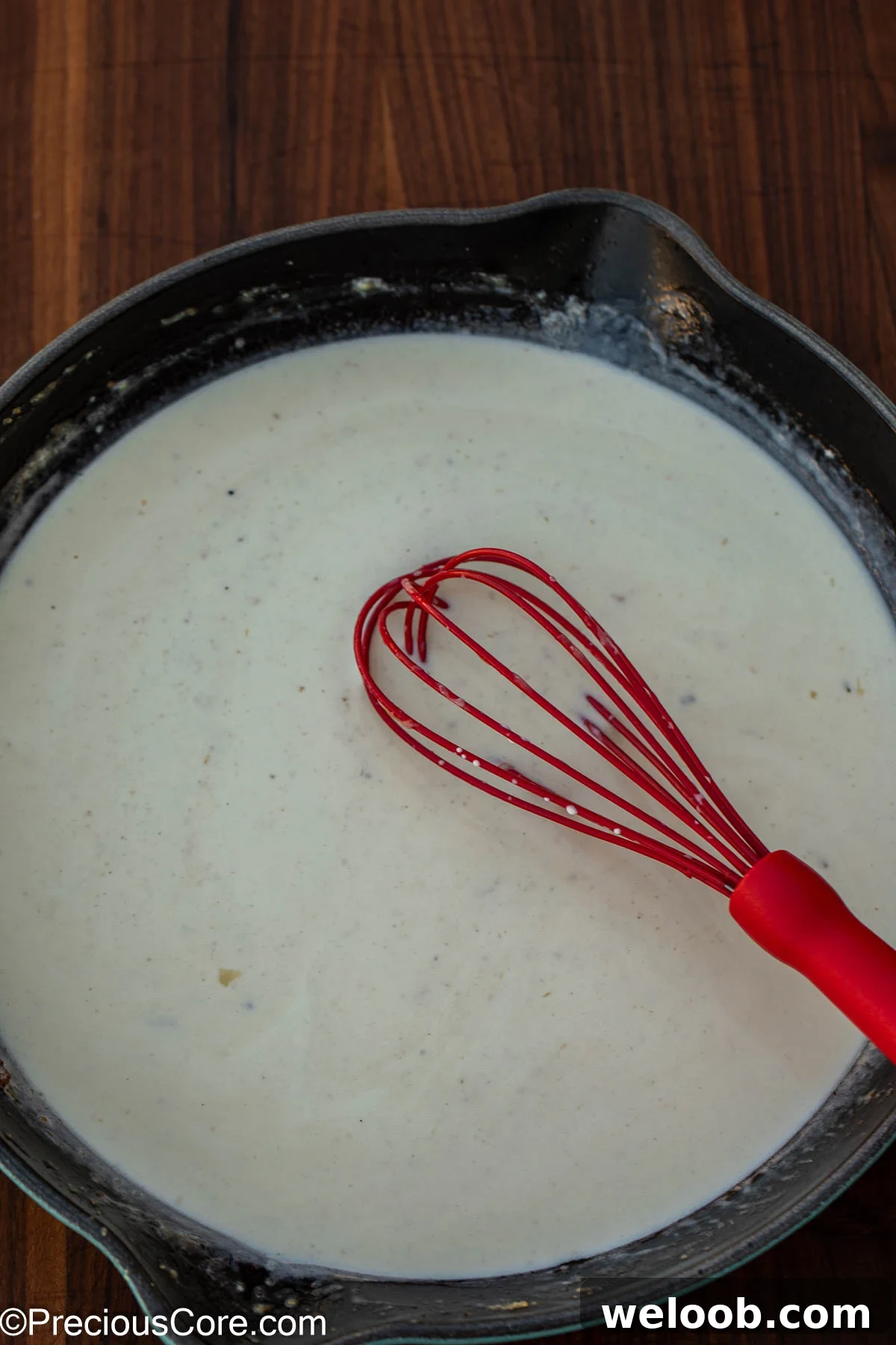 White sauce cooking in a pan.