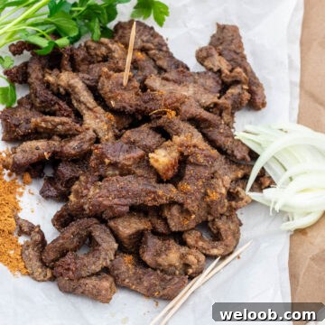 Cameroonian grilled meat on parchment paper, served with onions and soya pepper.