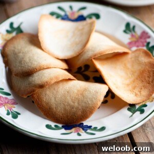 A close up of Tegole Valdostane (Italian cookies) on a plate.