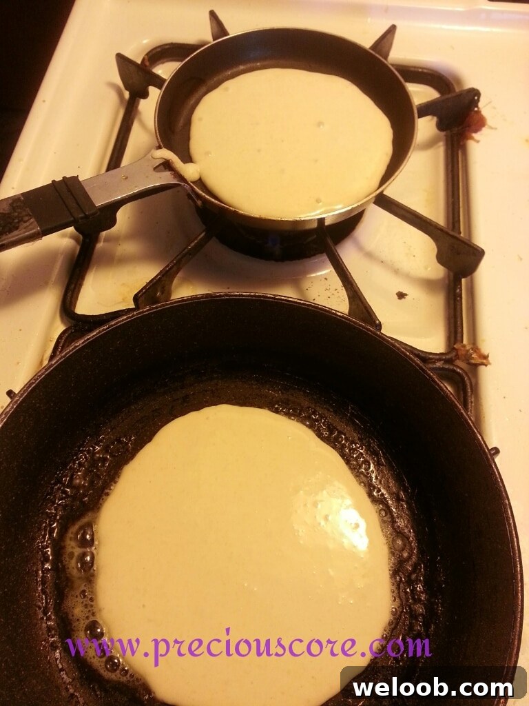 Pancakes cooking in a skillet