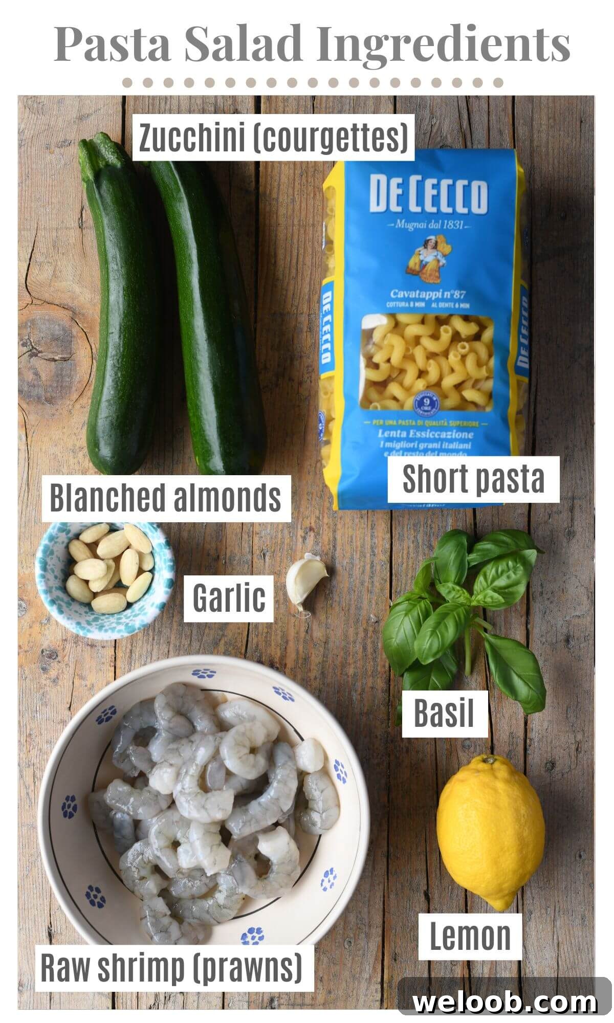 An overhead shot of all the ingredients needed to make a zucchini and shrimp pasta salad.