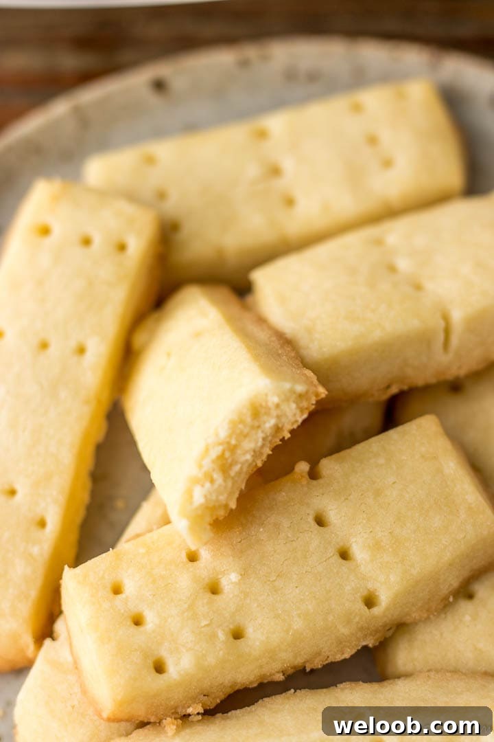 Shortbread cookies with one bitten to reveal crumbly texture
