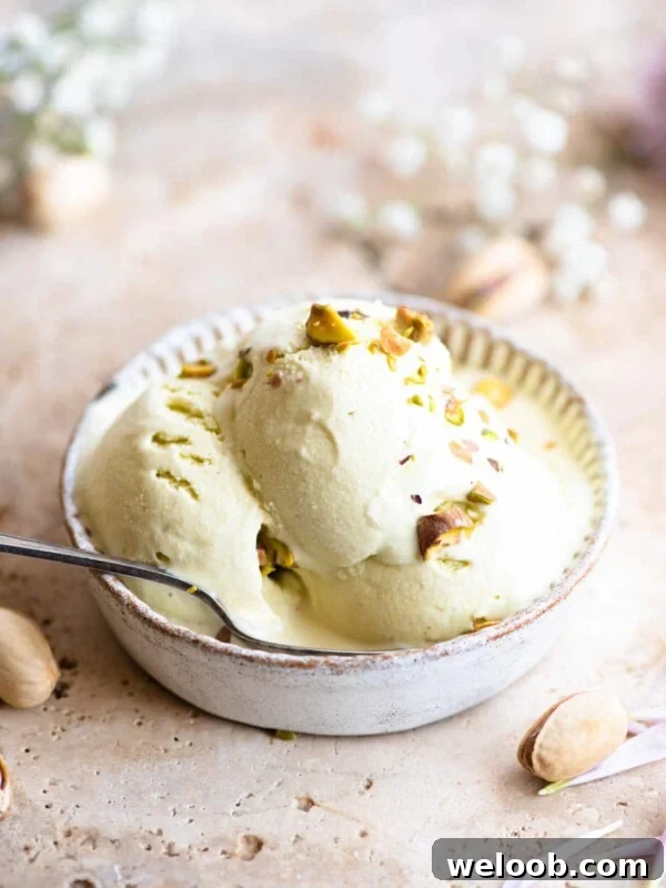 Three scoops of pistachio ice cream in a rustic looking ramekin
