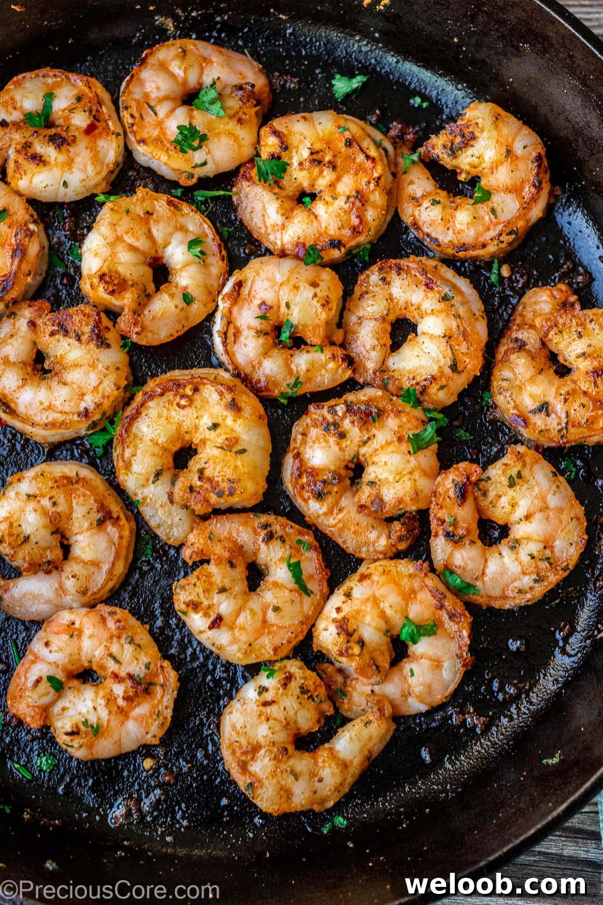 Pan seared shrimp in a skillet.