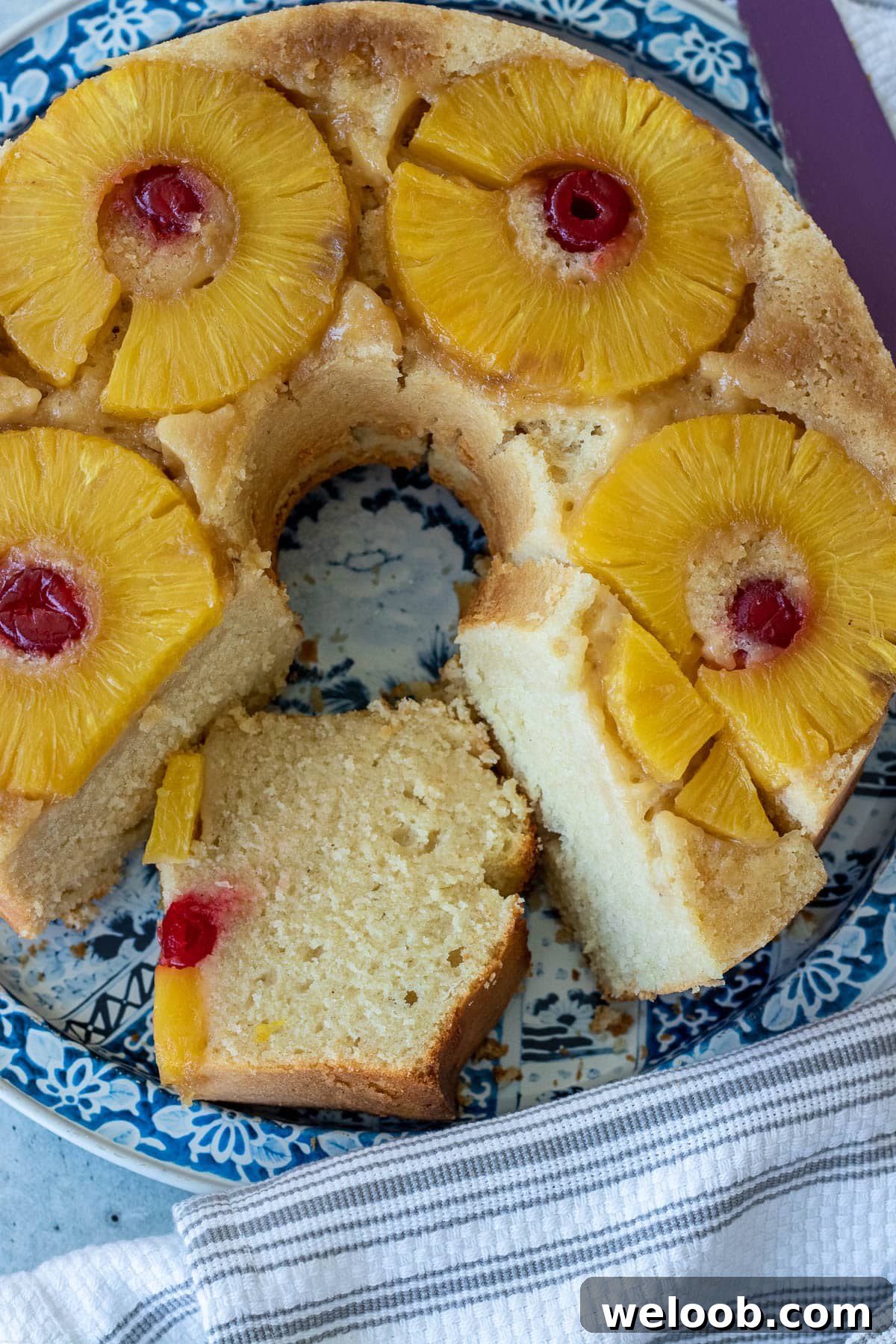 Pineapple Upside Down Pound Cake with pineapple slices and maraschino cherries.