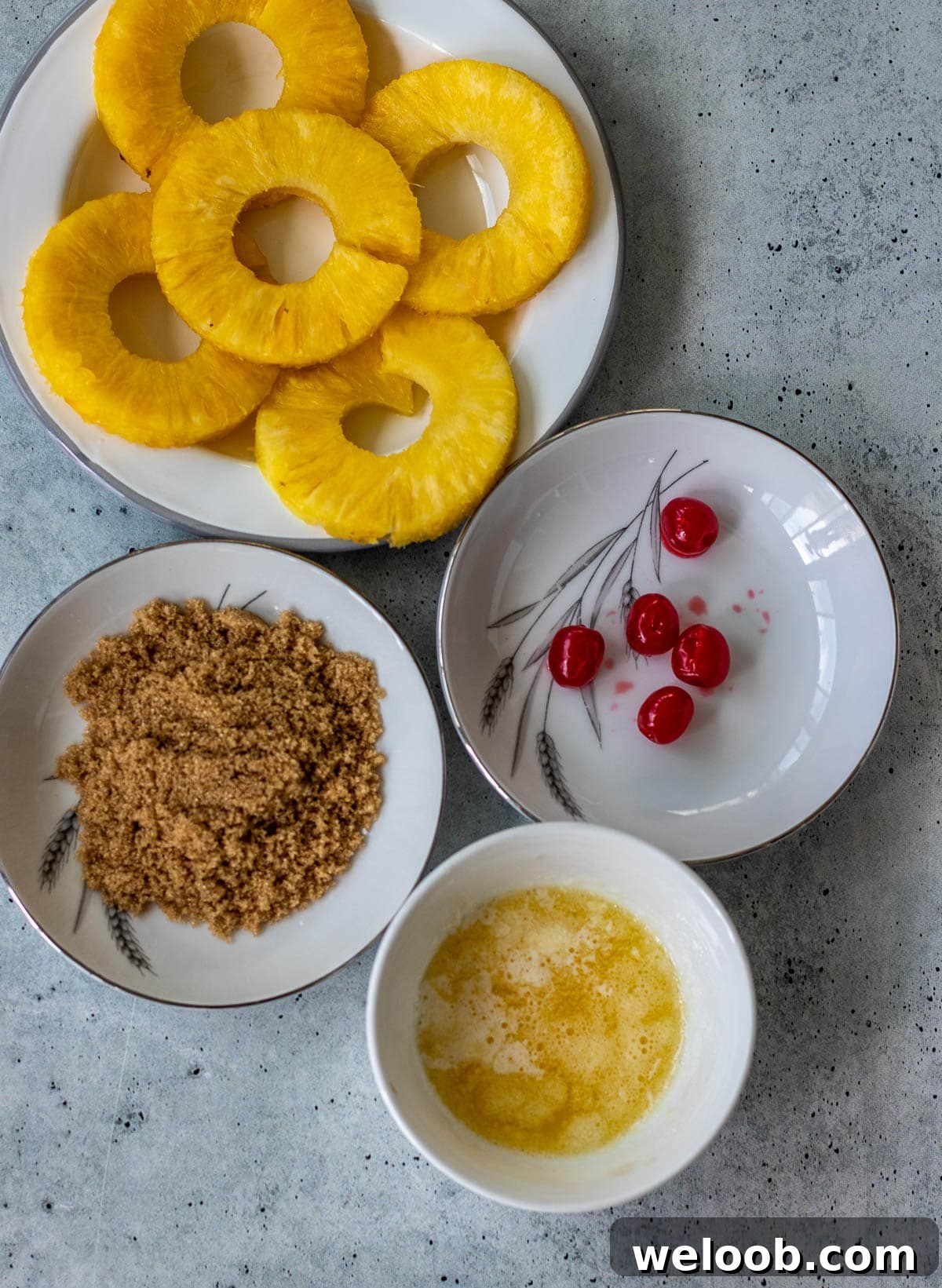 Pineapple rings, maraschino cherries, brown sugar, and melted butter.