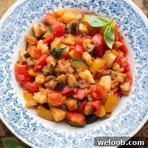 An overhead cropped image of Ciambotta Italian summer stew in a blue and white bowl.