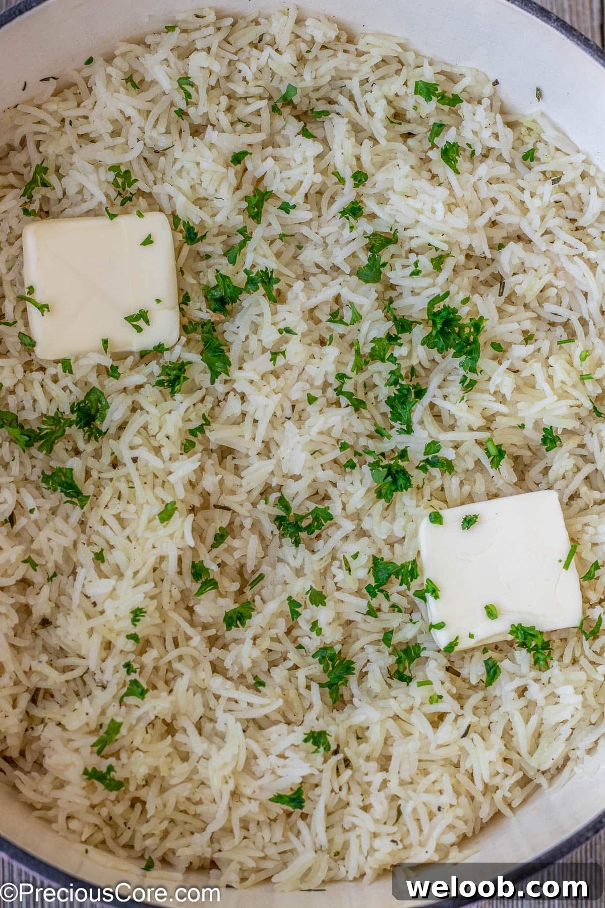 Rice topped with butter and minced parsley.