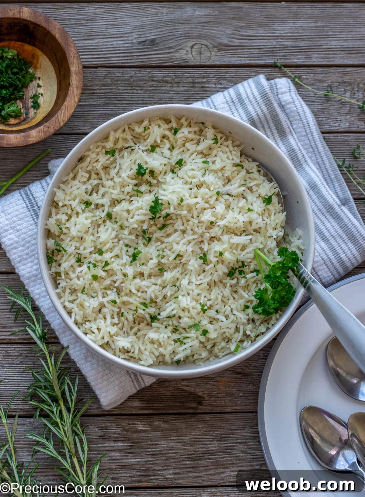 Bowl of seasoned rice with plates on one side.
